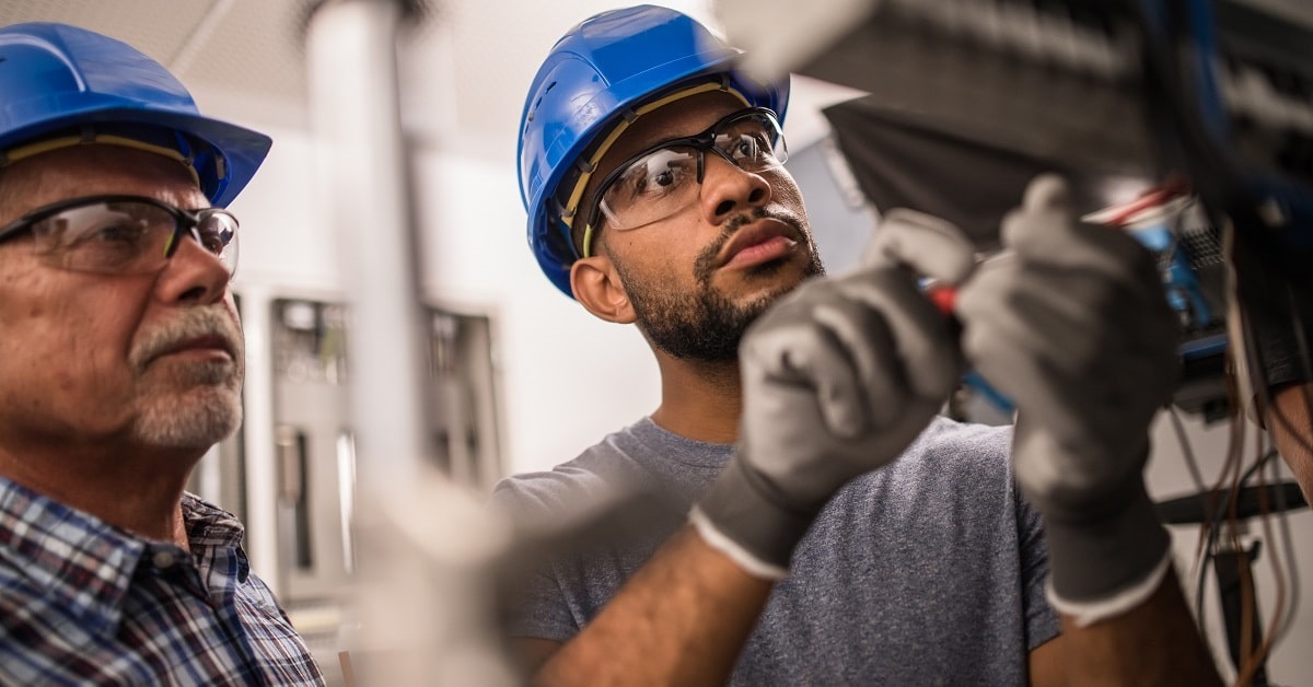 workers making sure business has power surge protection